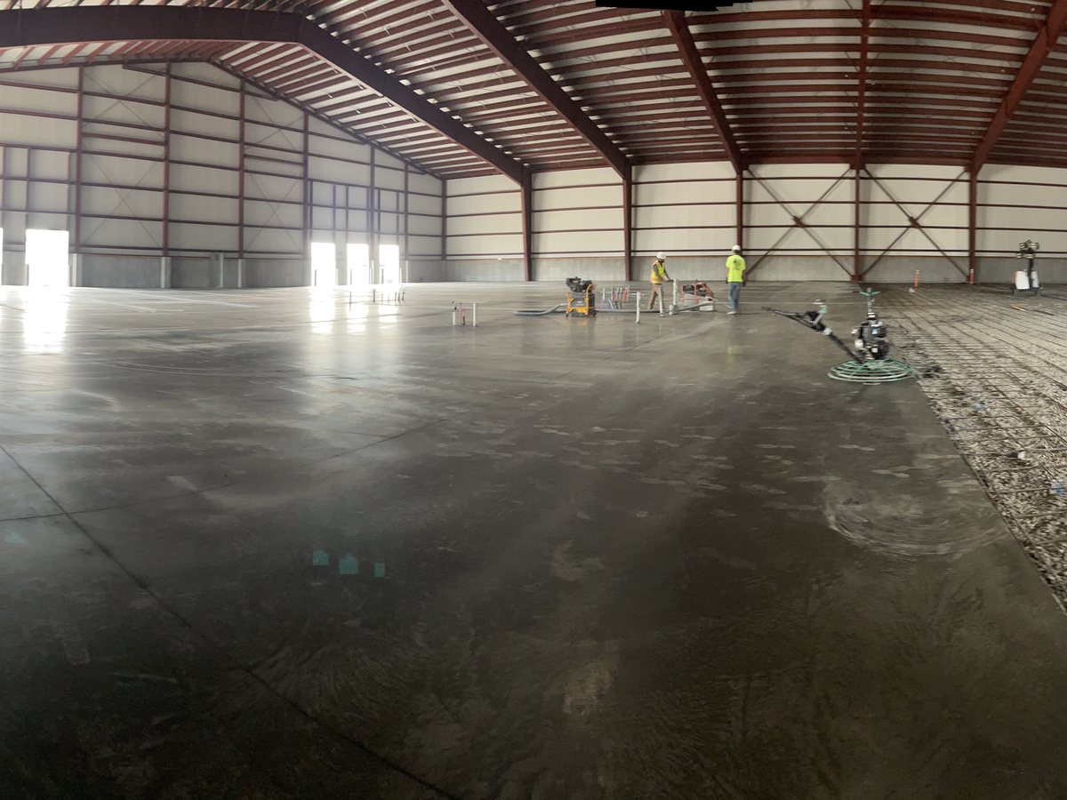 A crew placing and finishing a commercial concrete pour