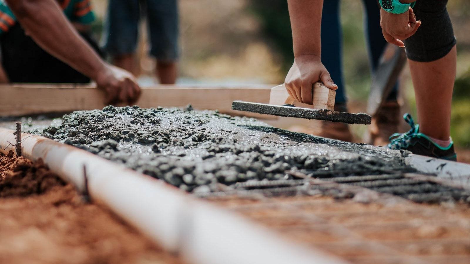 Fresh concrete being placed before it is stamped and colored